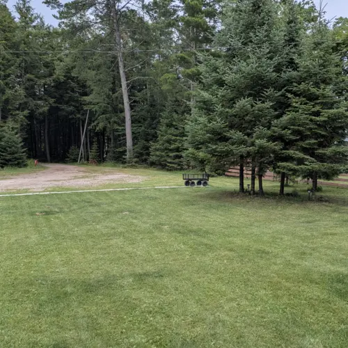 Ample free parking on premises at Smile Awhile in Eagle River, WI, with plenty of room for boat trailers, snowmobile haulers, and multiple vehicles.